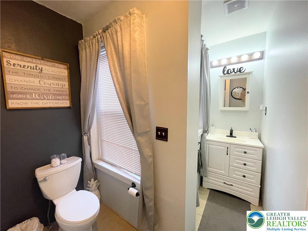 633 Maple Street Bethlehem, PA 18018 - Photo 10 of 14 a bathroom with a toilet sink and mirror