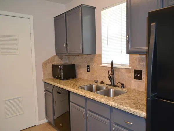 a kitchen with a sink and cabinets