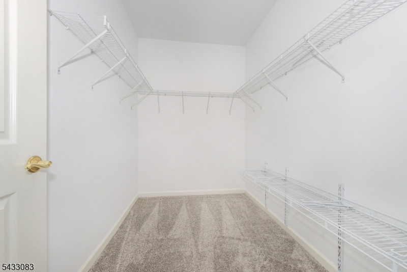 29 Ridgeview Lane, Unit 29 Mount Arlington, NJ 07856 - Photo 18 of 39 a view of a room with racks on the wall