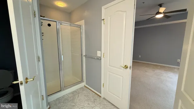 a view of staircase with white door and windows