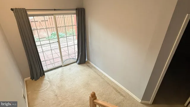 a view of a house with backyard and wooden fence