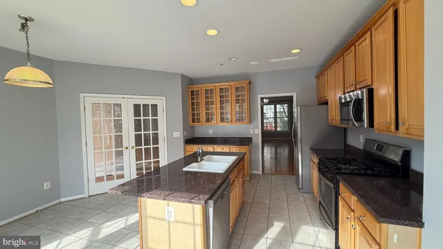 a kitchen with granite countertop sink stove and cabinets