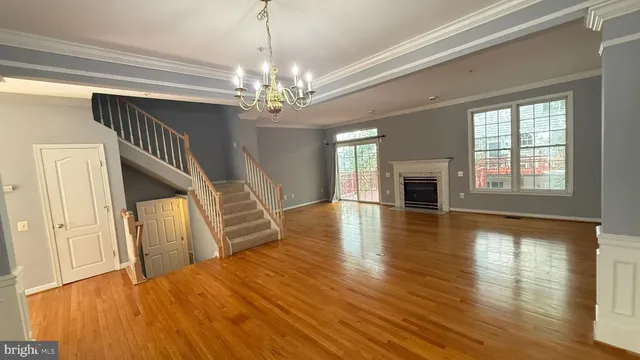 a view of a livingroom with wooden floor and fireplace