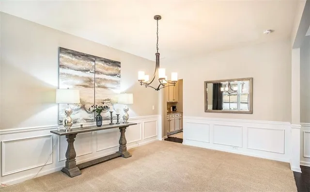 a living room with furniture a window and a glass door