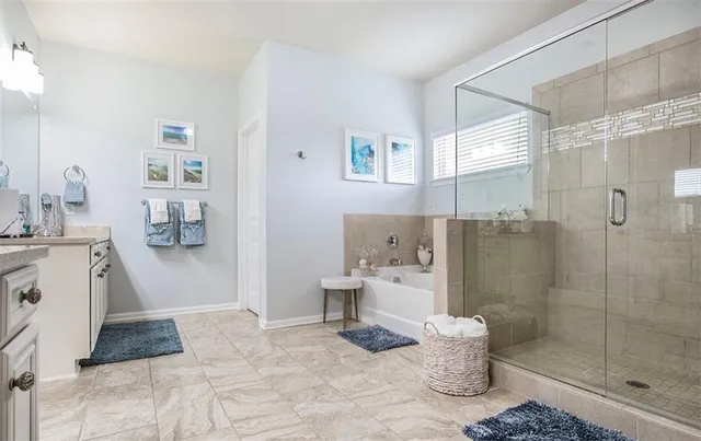 a large bathroom with a sink toilet and shower