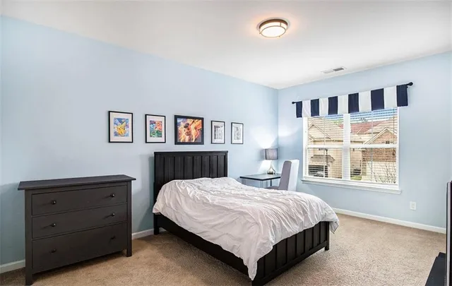 a bedroom with a large bed and a window