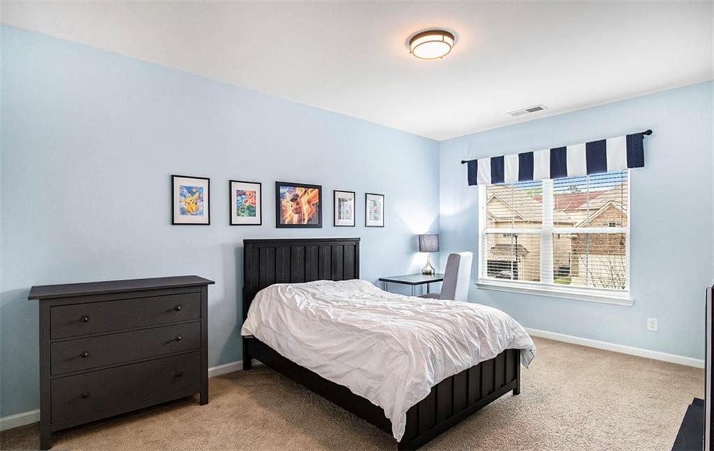 3217 Bowlin Drive Fairburn, GA 30213 - Photo 17 of 28 a bedroom with a large bed and a window