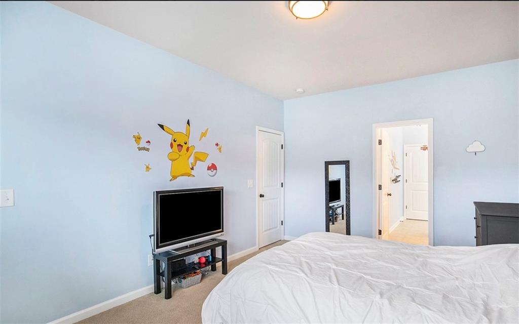 3217 Bowlin Drive Fairburn, GA 30213 - Photo 18 of 28 a bedroom with a bed and a flat screen tv