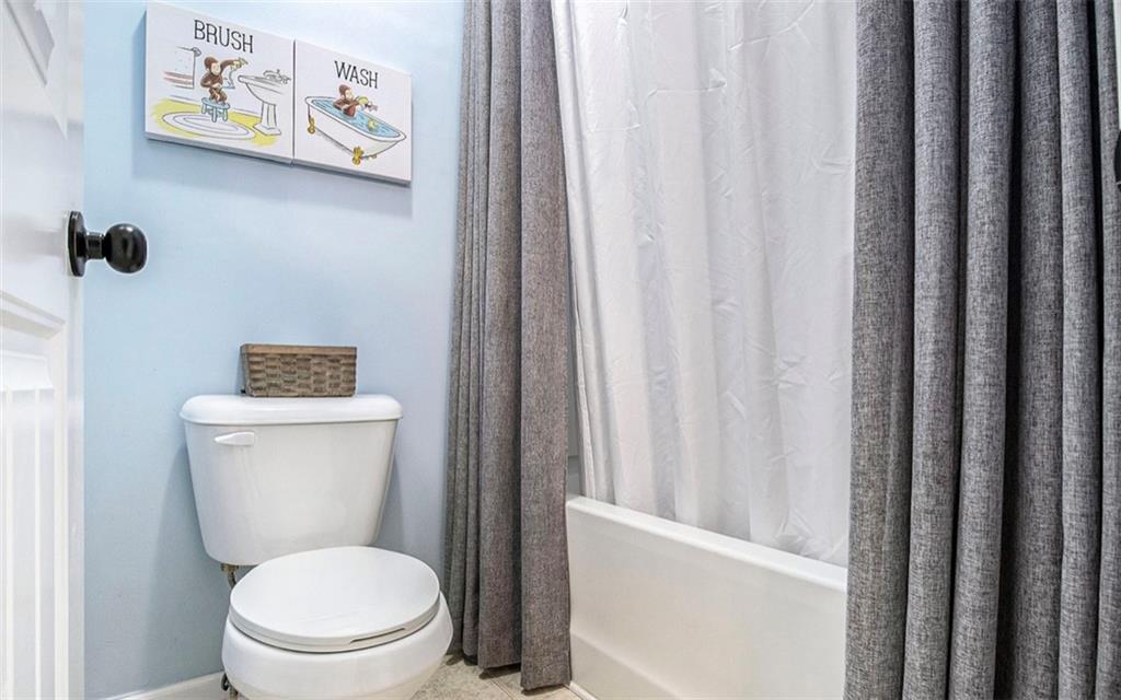 3217 Bowlin Drive Fairburn, GA 30213 - Photo 19 of 28 a white toilet sitting next to a small bathroom sink