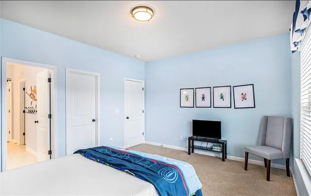 a bedroom with a bed and a chair in it