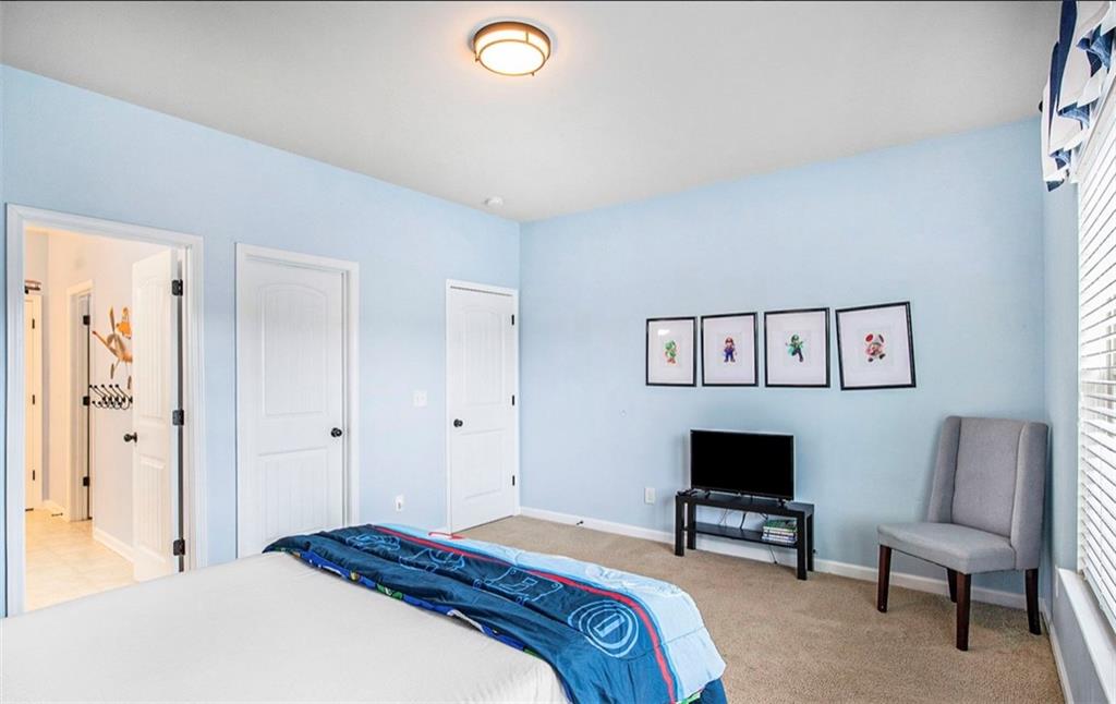 3217 Bowlin Drive Fairburn, GA 30213 - Photo 21 of 28 a bedroom with a bed and a chair in it