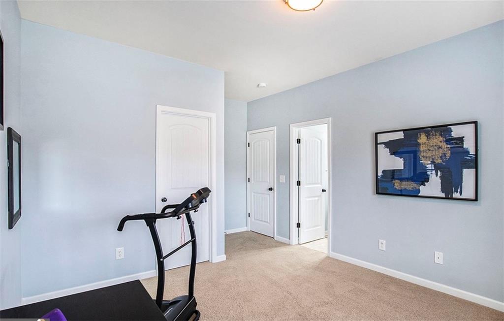 3217 Bowlin Drive Fairburn, GA 30213 - Photo 23 of 28 a view of a hallway with paintings on the wall