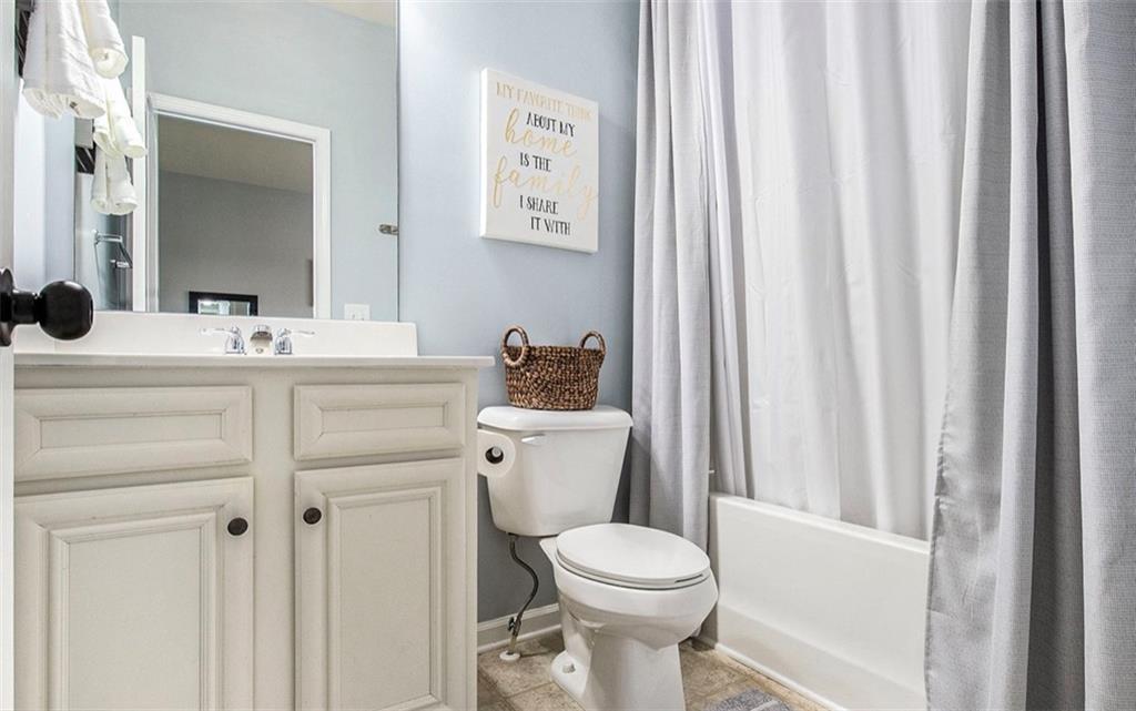 3217 Bowlin Drive Fairburn, GA 30213 - Photo 24 of 28 a bathroom with a sink a toilet and a mirror