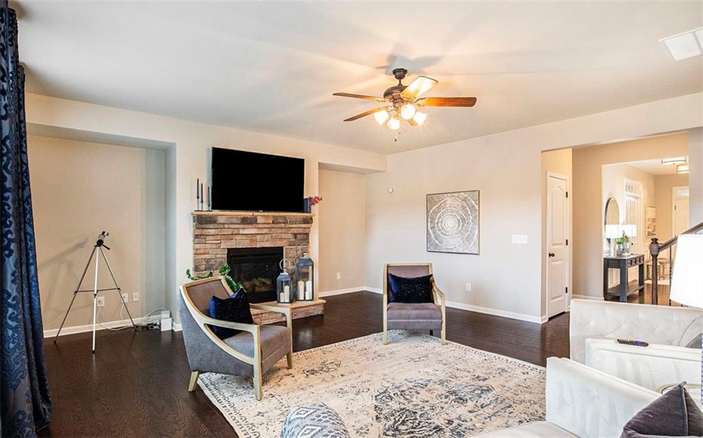 3217 Bowlin Drive Fairburn, GA 30213 - Photo 3 of 28 a living room with furniture a flat screen tv and a fireplace