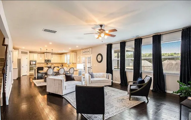 a living room with furniture and a large window