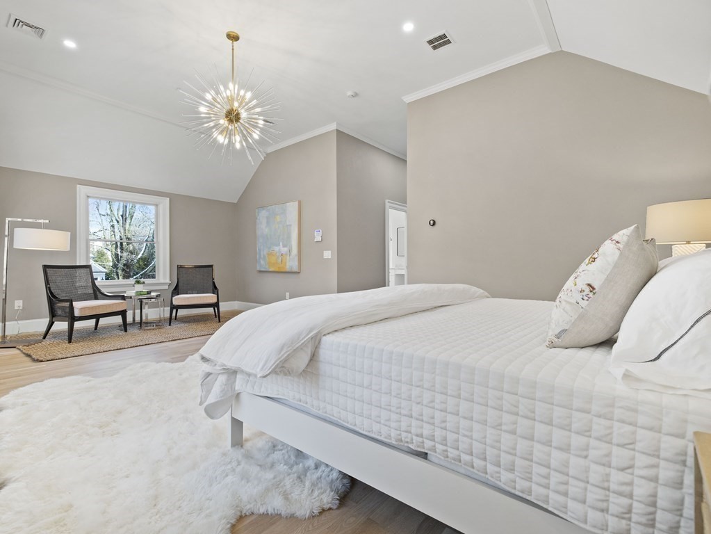117 Abbott Road Wellesley, MA 02481 - Photo 18 of 34 a bedroom with bed and a chandelier