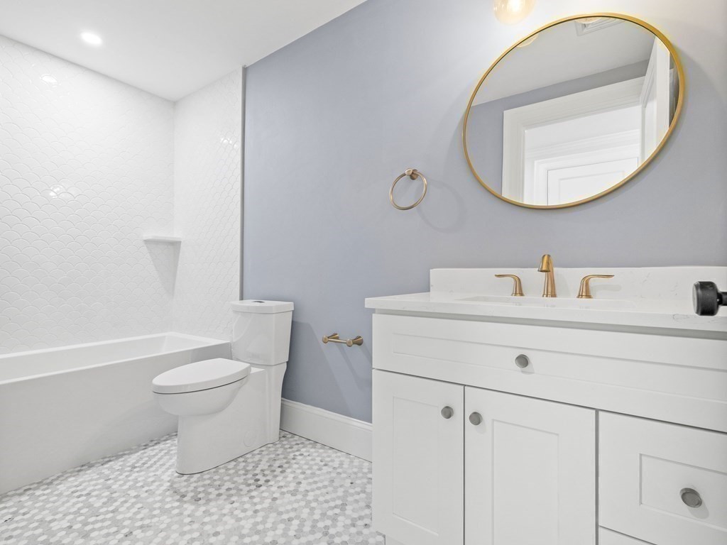 117 Abbott Road Wellesley, MA 02481 - Photo 20 of 34 a bathroom with a sink a toilet and a mirror