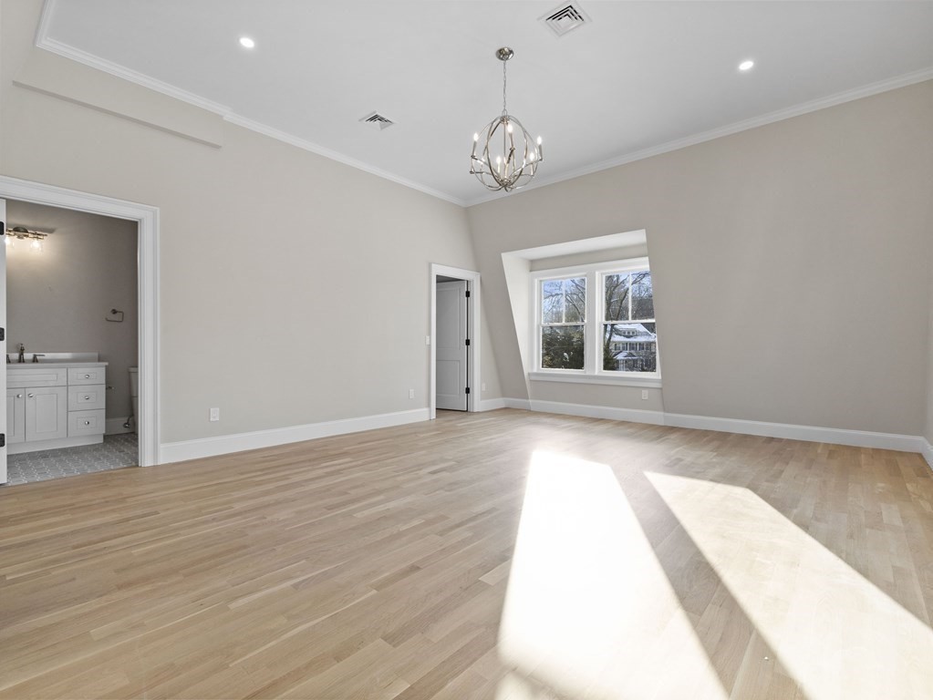 117 Abbott Road Wellesley, MA 02481 - Photo 24 of 34 a view of an empty room with wooden floor and a window