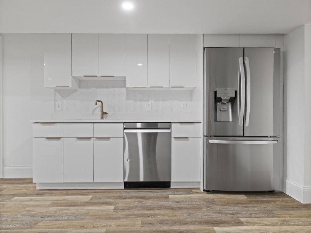 117 Abbott Road Wellesley, MA 02481 - Photo 26 of 34 a white refrigerator freezer and a wooden floor