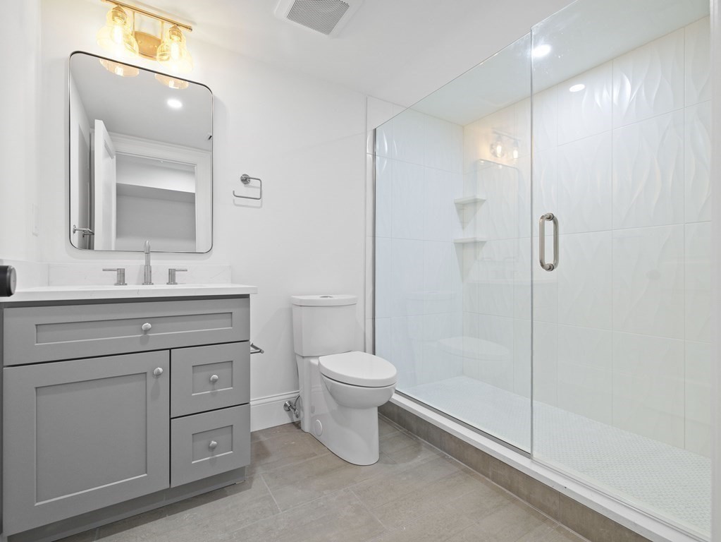 117 Abbott Road Wellesley, MA 02481 - Photo 27 of 34 a bathroom with a toilet sink and a mirror