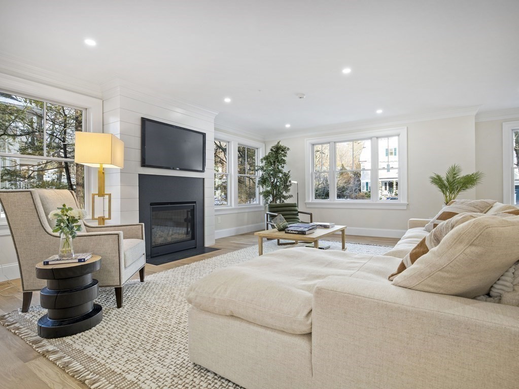 117 Abbott Road Wellesley, MA 02481 - Photo 4 of 34 a living room with furniture a fireplace and a potted plant