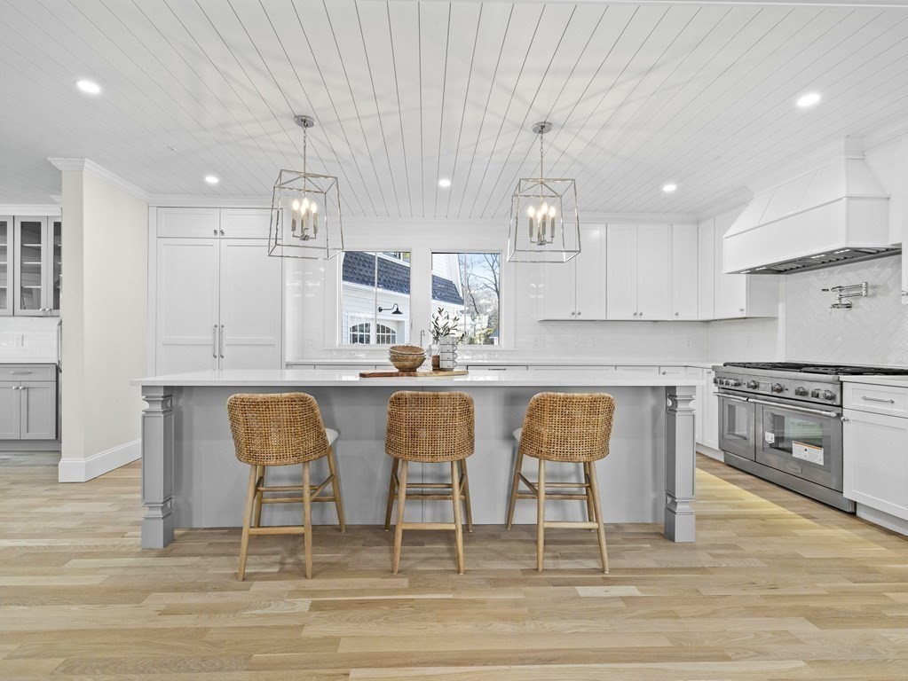 117 Abbott Road Wellesley, MA 02481 - Photo 6 of 34 a kitchen with stainless steel appliances kitchen island granite countertop a table chairs sink and cabinets