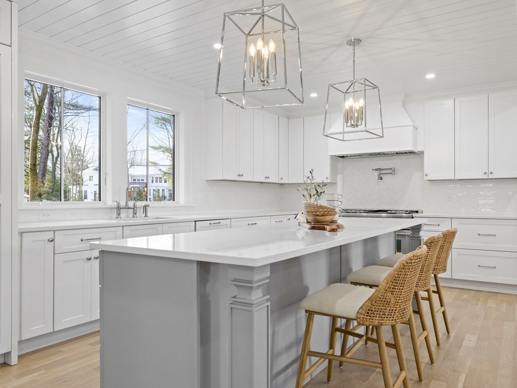 117 Abbott Road Wellesley, MA 02481 - Photo 7 of 34 a kitchen with stainless steel appliances a table chairs and a chandelier