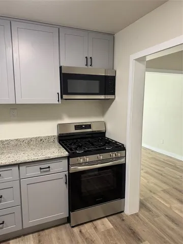 a kitchen with granite countertop a stove and a sink