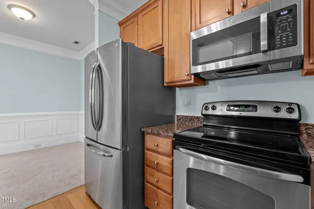 a kitchen with granite countertop a refrigerator and a sink