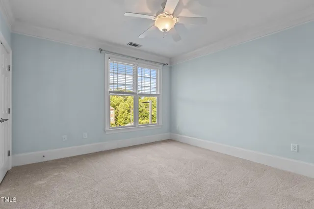 a view of a livingroom with a bathroom space and a ceiling fan