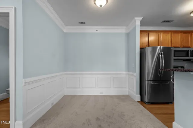 a living room with a flat screen tv and a white door