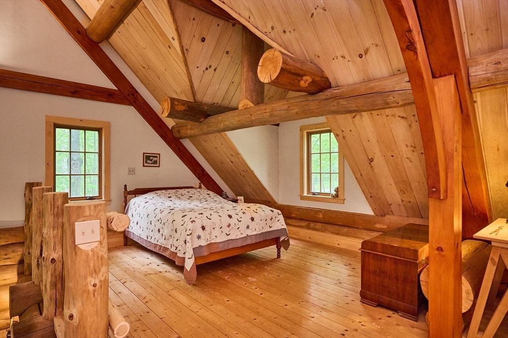 486 Old Stage Road Ashfield, MA 01330 - Photo 5 of 36 a bedroom with a bed and wooden floor
