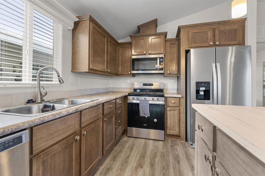 8545 Mission Gorge Road, Unit 253A Santee, CA 92071 - Photo 4 of 21 a kitchen with stainless steel appliances a refrigerator sink and microwave