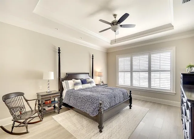a living room with a bed furniture and a large window
