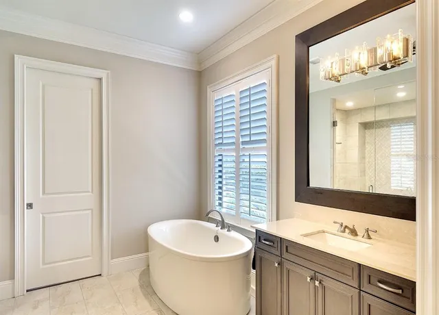 a bathroom with a double vanity sink mirror and bathtub