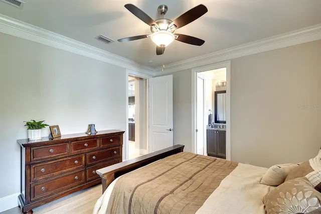 a bedroom with a bed and ceiling fan