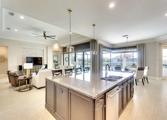 a large kitchen with lots of counter space and chandelier