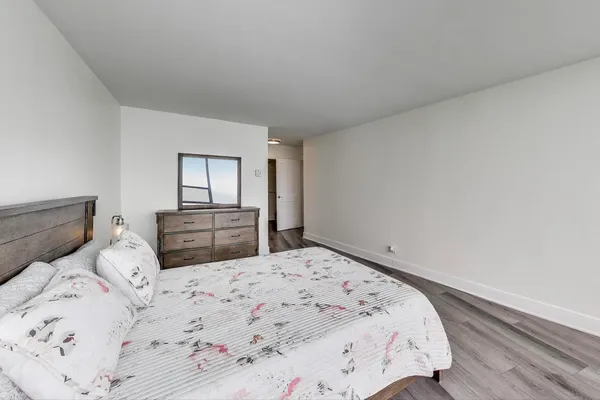 a bedroom with a bed and a lamp