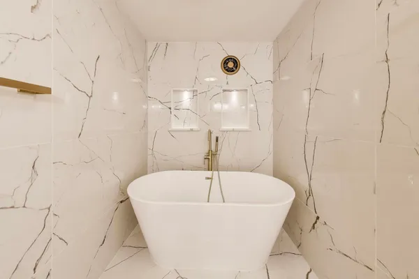 a white bath tub sitting in a bathroom