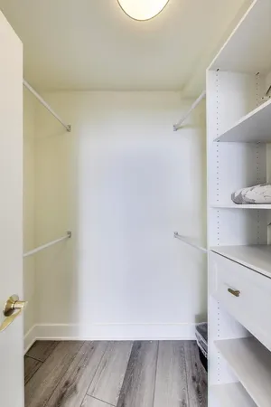 a view of a room with wooden floor and cabinet