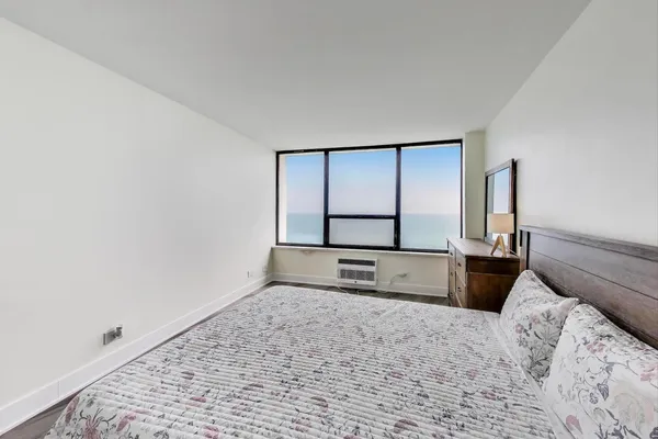 a bedroom with a bed and a dresser next to it