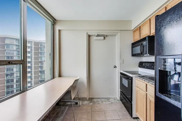 a kitchen with stainless steel appliances a refrigerator and a stove