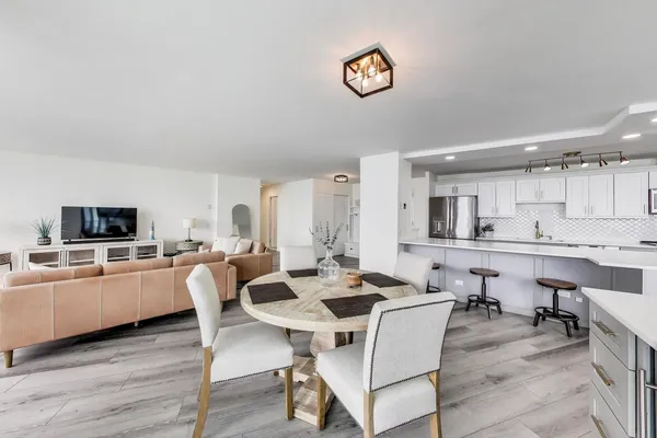 a view of a dining room with furniture and a kitchen