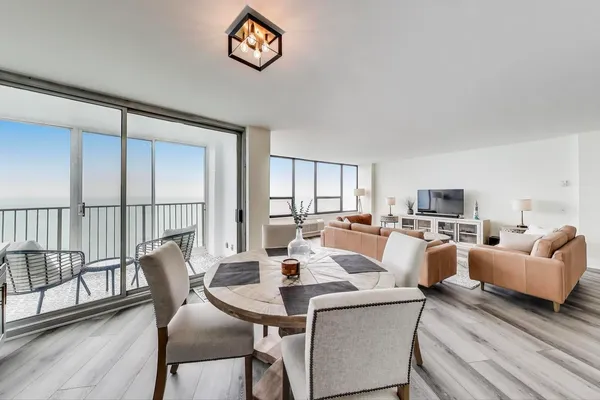 a view of a dining room with furniture window and wooden floor