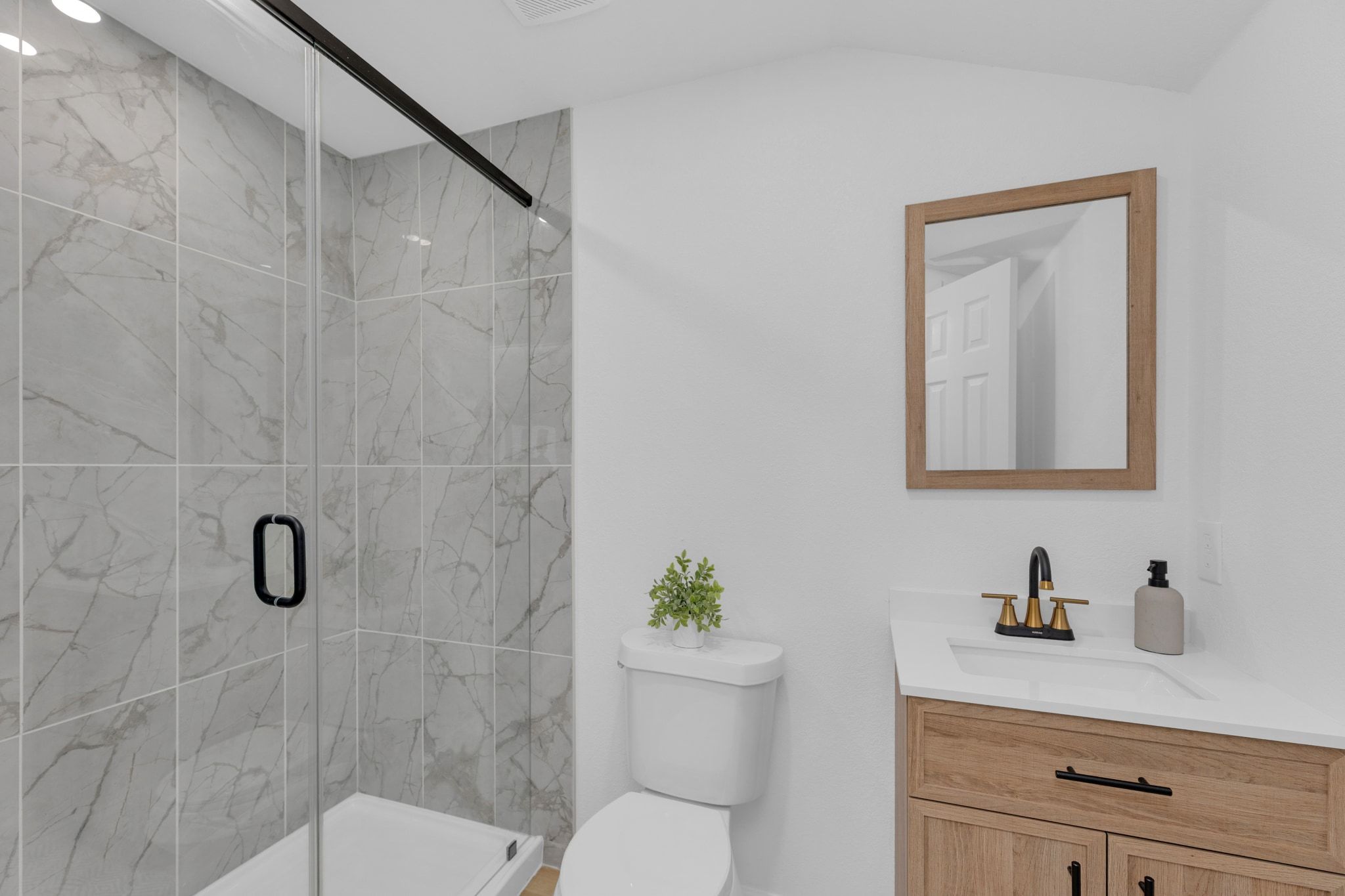 1709 Cecelia Street Taylor, TX 76574 - Photo 22 of 37 Bathroom featuring a marble finish shower and vanity