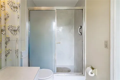 a bathroom with a shower and a toilet