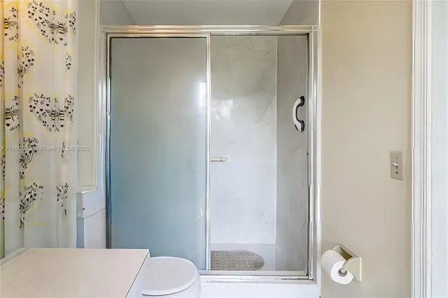 a bathroom with a shower and a toilet