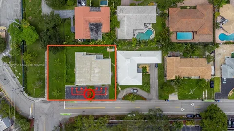 an aerial view of residential houses with outdoor space and street view