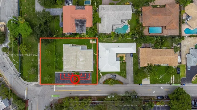 an aerial view of residential houses with outdoor space and street view