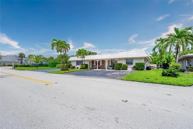 a front view of house with a yard and green space